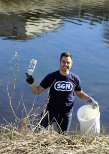 SGN's Josh Yguado retrieves a discarded plastic bottle.