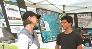 Erick Perez explains Ballona Creek to a visitor to the BCR booth at Del Rey Day.